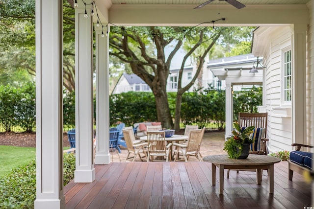 wooden deck featuring ceiling fan