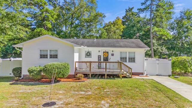 view of front of house with a front yard and a deck