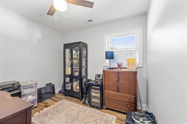 home office featuring light wood-type flooring and ceiling fan