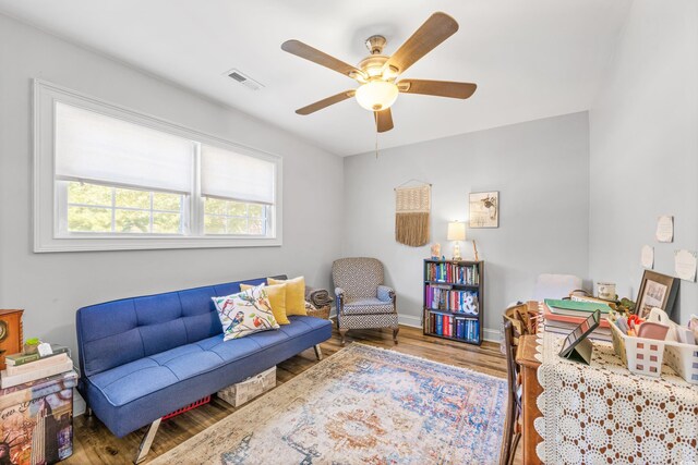 living room featuring hardwood / wood-style flooring and ceiling fan