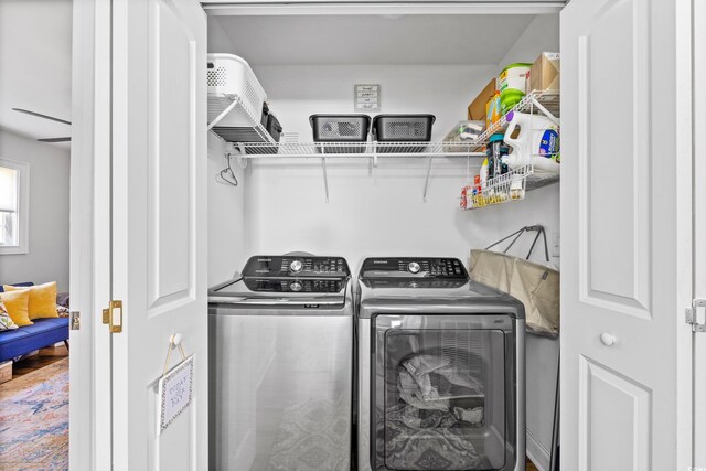 laundry room featuring independent washer and dryer and hardwood / wood-style flooring