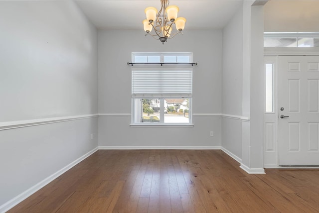 foyer featuring hardwood / wood-style floors and a notable chandelier