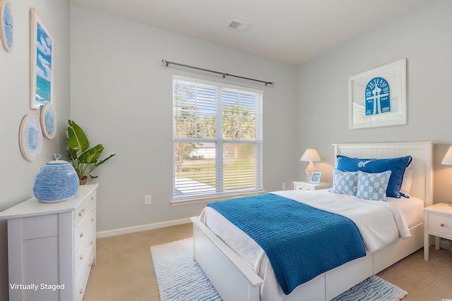 bedroom featuring light carpet, baseboards, and visible vents