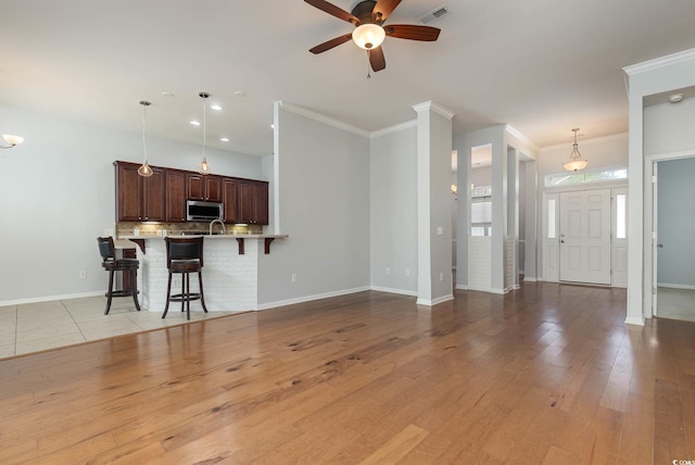 323 Trestle Way, Conway, SC 29526 - living room featuring a ceiling fan, baseboards, light wood-style floors, crown molding, and recessed lighting