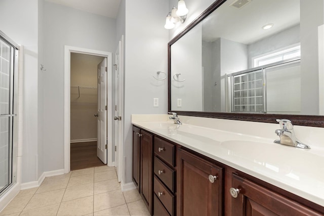 bathroom featuring vanity, walk in shower, and tile patterned floors