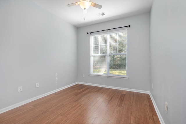 empty room with hardwood / wood-style floors and ceiling fan