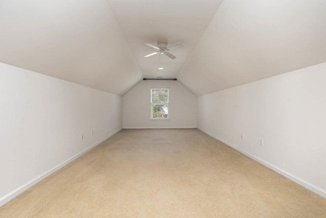 additional living space with ceiling fan, light carpet, and lofted ceiling