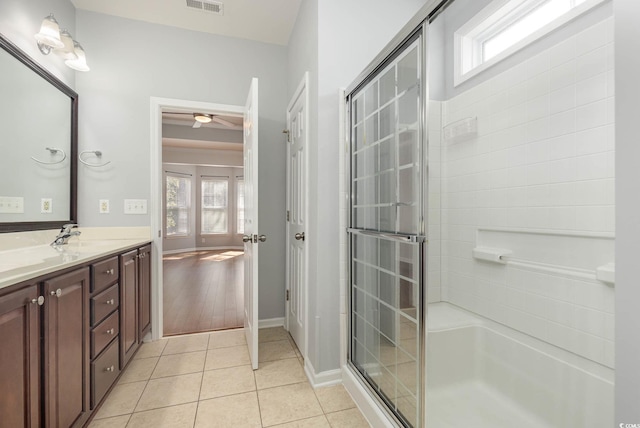 bathroom featuring a shower with shower door, tile patterned floors, vanity, and plenty of natural light