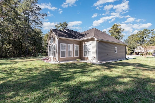 view of property exterior with a lawn