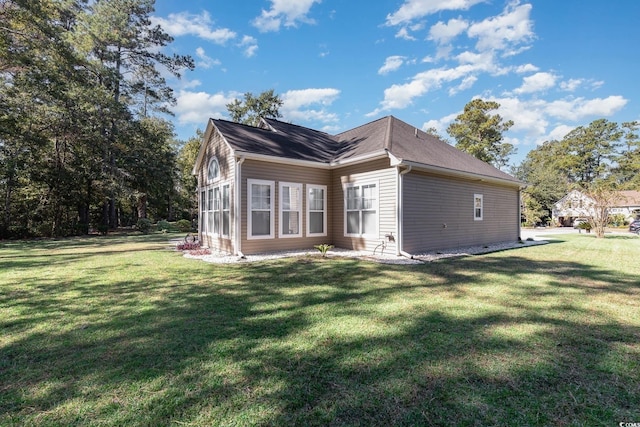 rear view of property featuring a yard