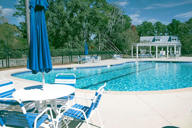 view of swimming pool with a patio area