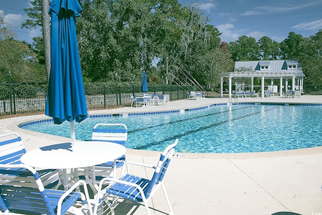 323 Trestle Way, Conway, SC 29526 - community pool featuring a pergola, a patio area, and view of wooded area