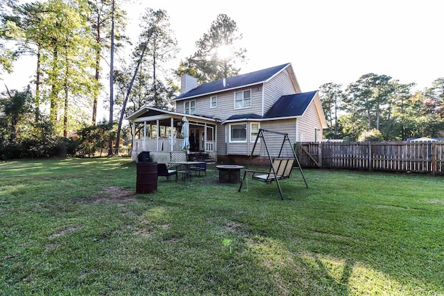 back of house featuring a sunroom and a yard