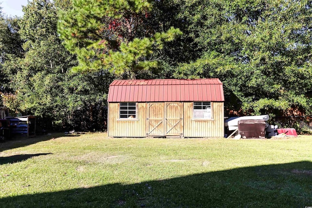 view of outbuilding with a yard