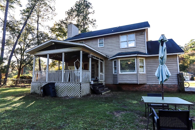 rear view of property with a lawn