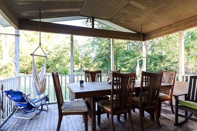 sunroom / solarium with a healthy amount of sunlight and lofted ceiling