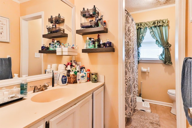 bathroom with vanity, tile patterned flooring, toilet, ornamental molding, and a textured ceiling