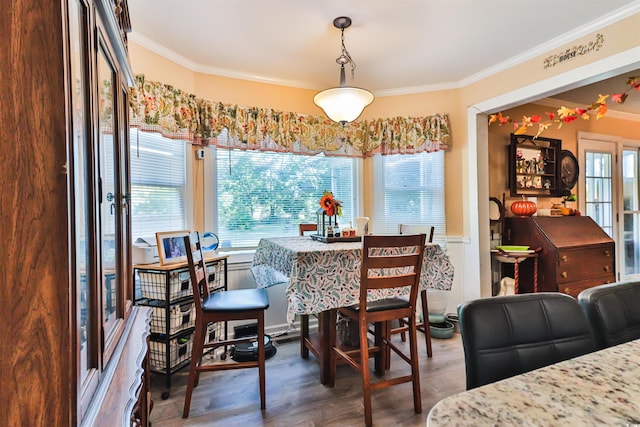 dining room featuring crown molding and dark wood-type flooring