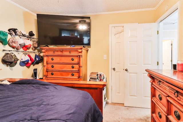 bedroom featuring light carpet, a textured ceiling, and ornamental molding