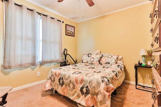 carpeted bedroom featuring ceiling fan, crown molding, and a textured ceiling