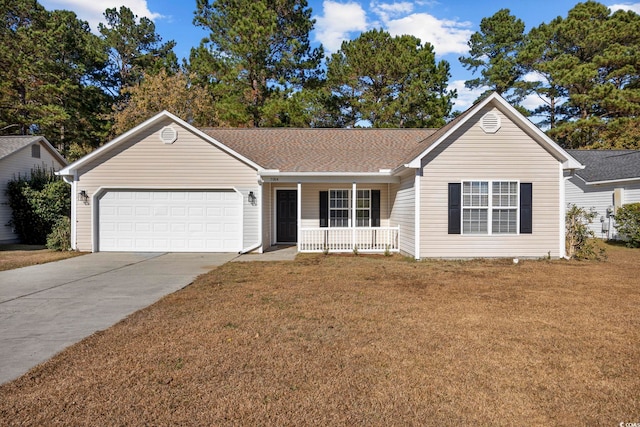 ranch-style house featuring covered porch, a garage, and a front lawn