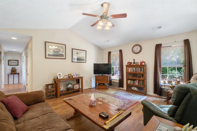 living room with lofted ceiling, light wood-type flooring, and ceiling fan