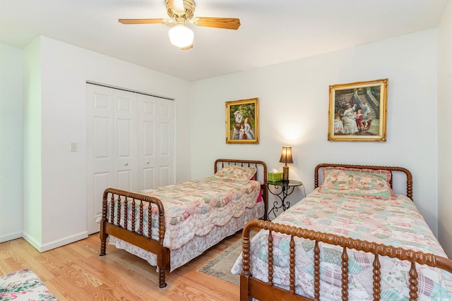 bedroom featuring light hardwood / wood-style flooring, a closet, and ceiling fan