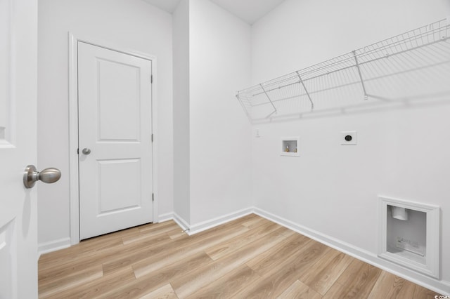 clothes washing area featuring light hardwood / wood-style floors, electric dryer hookup, and washer hookup