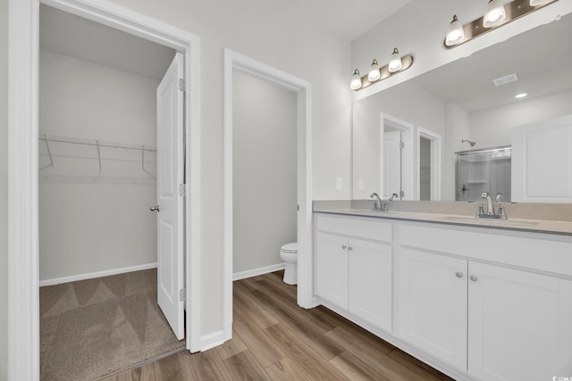 389 Sun Colony Blvd, Longs, SC 29568 - full bath featuring double vanity, an enclosed shower, wood finished floors, and a spacious closet