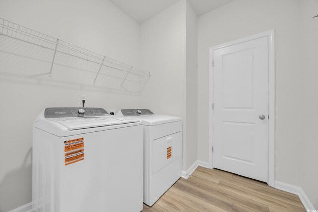 389 Sun Colony Blvd, Longs, SC 29568 - laundry room featuring washing machine and clothes dryer and light wood-type flooring