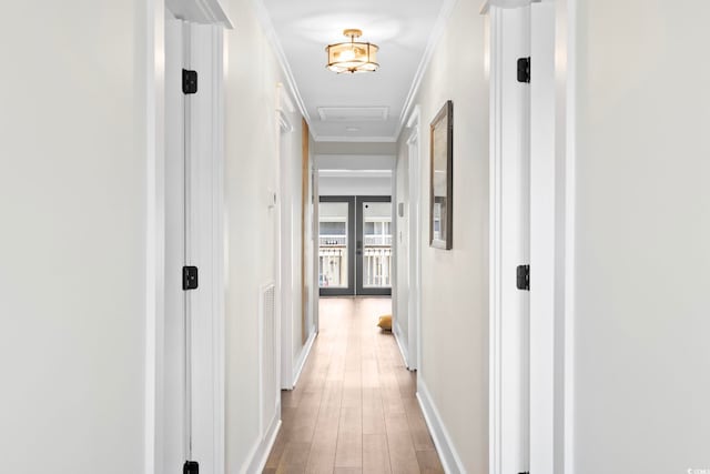 hallway featuring crown molding, french doors, and wood-type flooring