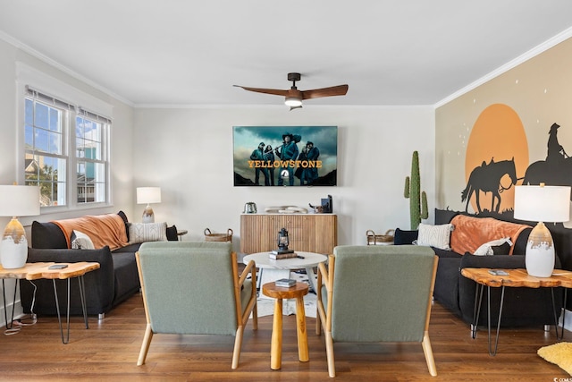 living room with crown molding, wood-type flooring, and ceiling fan