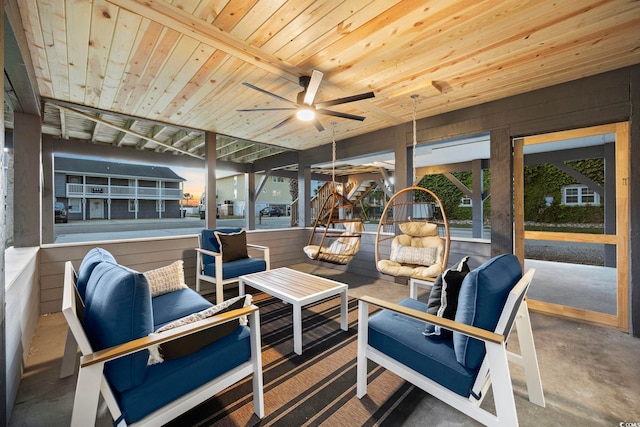 sunroom featuring wood ceiling and ceiling fan