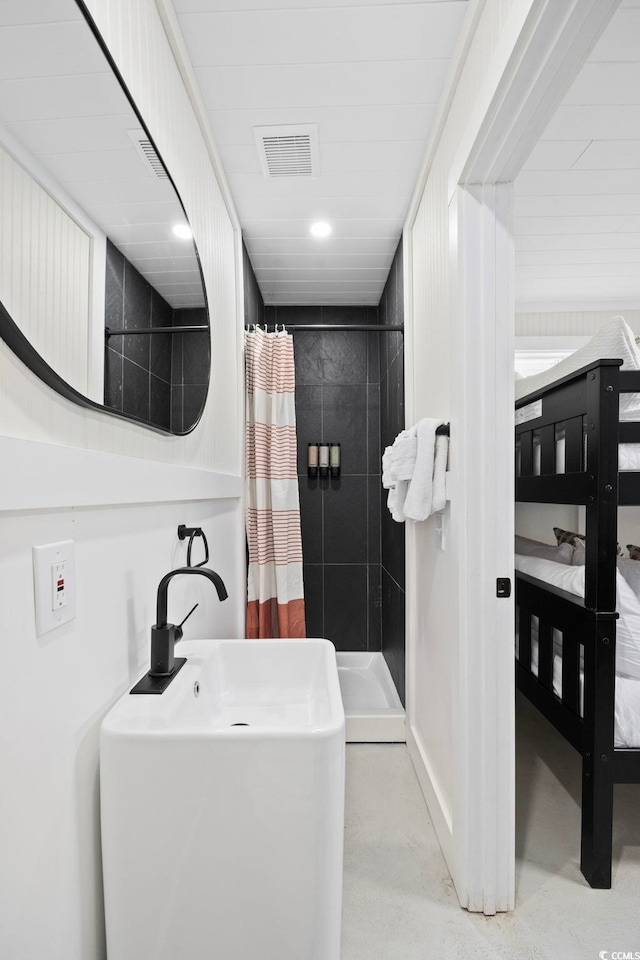 bathroom featuring walk in shower and concrete flooring