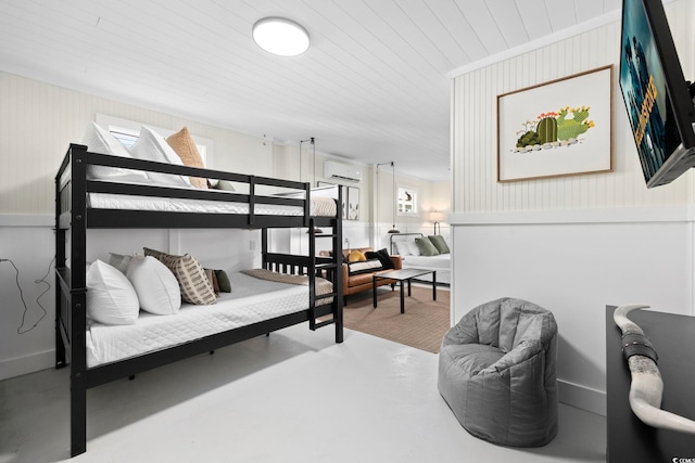 bedroom featuring concrete floors, an AC wall unit, and wooden ceiling