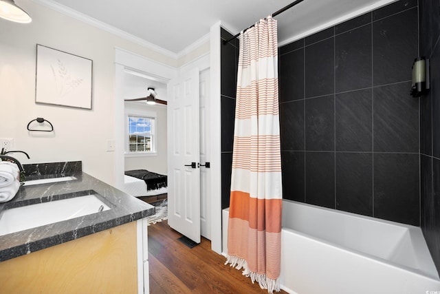 bathroom featuring vanity, ornamental molding, shower / bathtub combination with curtain, and wood-type flooring