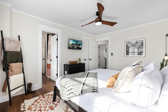 bedroom featuring crown molding, dark wood-type flooring, and ceiling fan