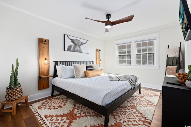 bedroom with ornamental molding, hardwood / wood-style flooring, and ceiling fan