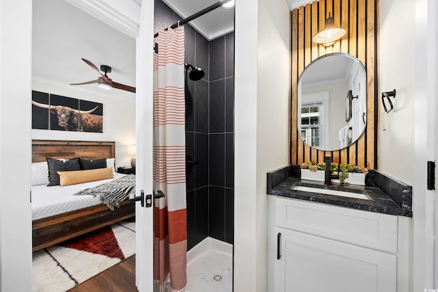 bathroom featuring wood-type flooring, ceiling fan, a shower with curtain, vanity, and crown molding