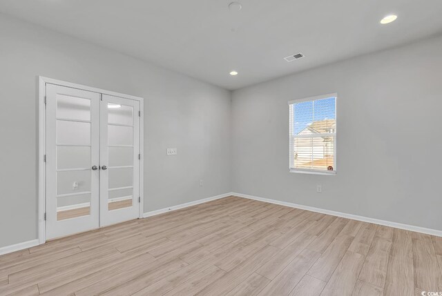 unfurnished room with light hardwood / wood-style flooring