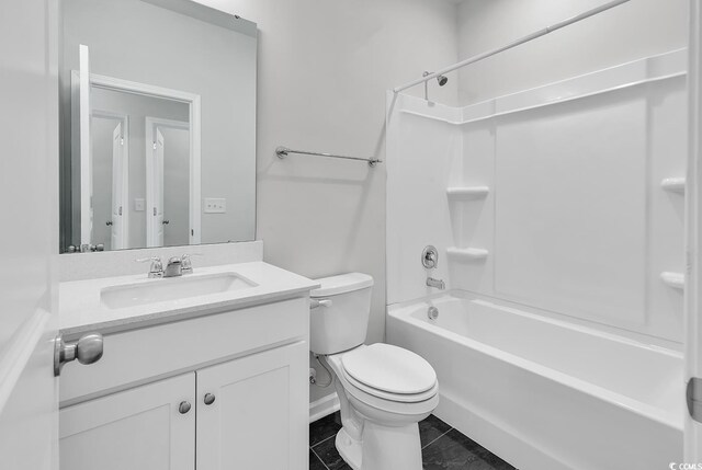 full bathroom featuring washtub / shower combination, tile patterned floors, vanity, and toilet