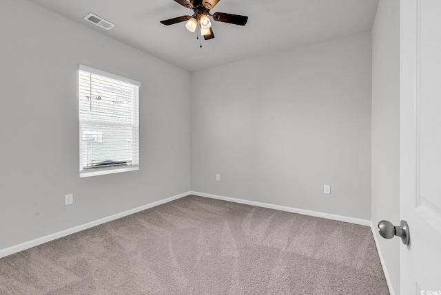 carpeted spare room featuring ceiling fan