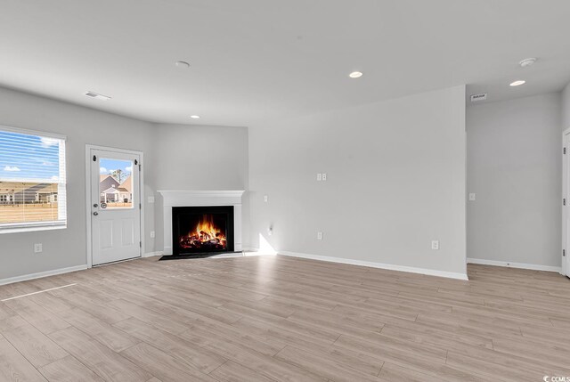 unfurnished living room with light hardwood / wood-style flooring