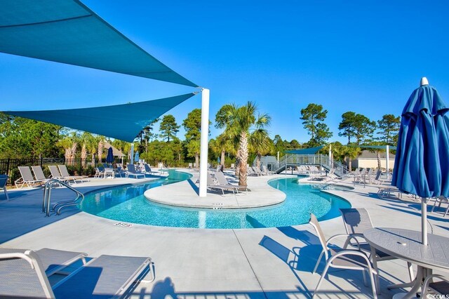 view of swimming pool with a patio