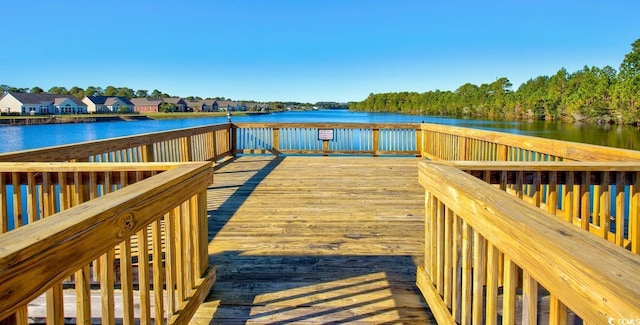 view of dock featuring a deck with water view