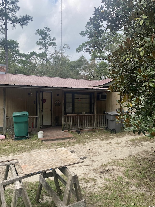 back of house with covered porch