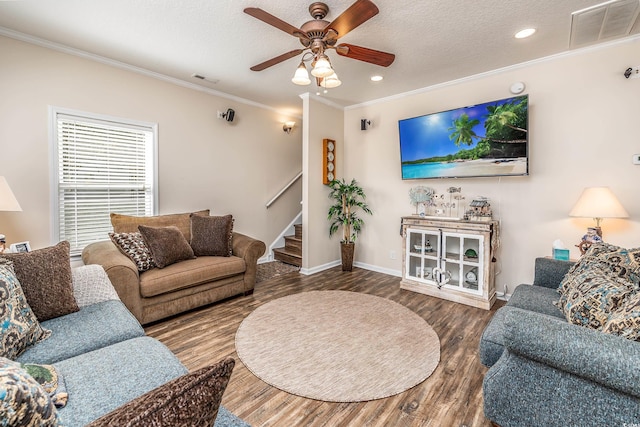 living room featuring ornamental molding, a textured ceiling, hardwood / wood-style floors, and ceiling fan