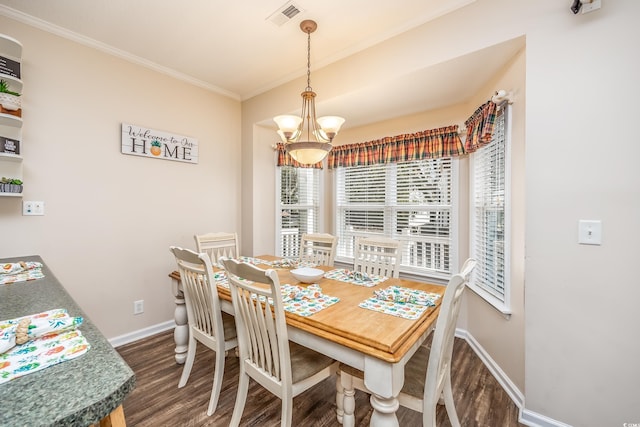 dining room featuring ornamental molding, a chandelier, and dark hardwood / wood-style flooring