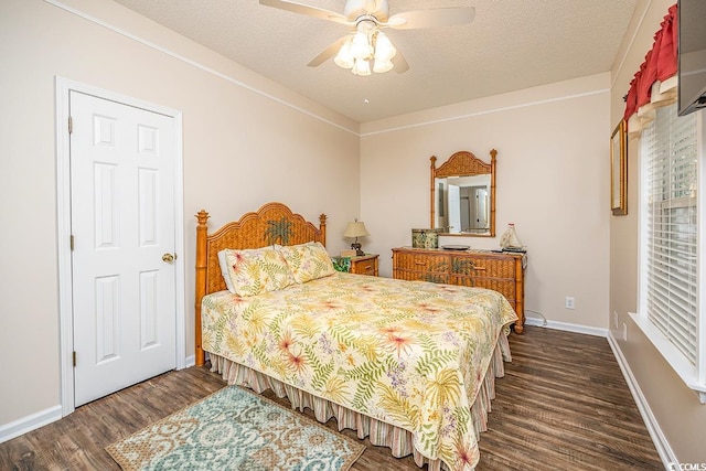 bedroom featuring a textured ceiling, dark wood-type flooring, and ceiling fan