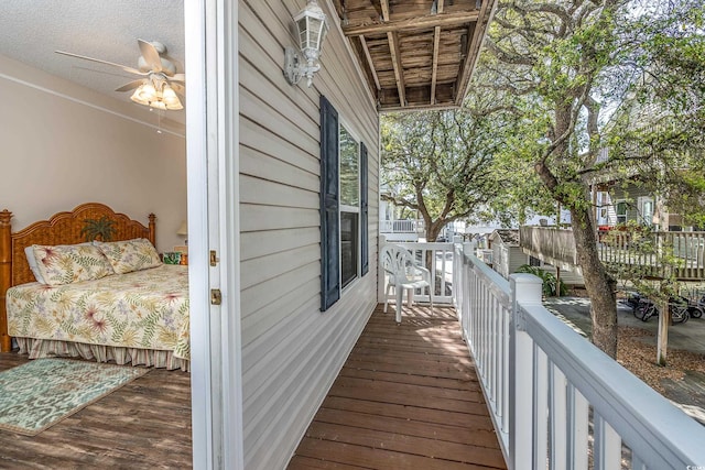 wooden terrace featuring ceiling fan